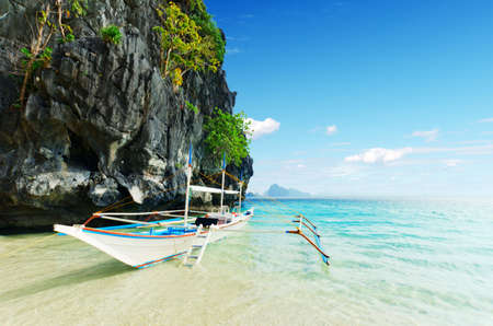 Tropical sea landscape. Boat on the beach.の写真素材