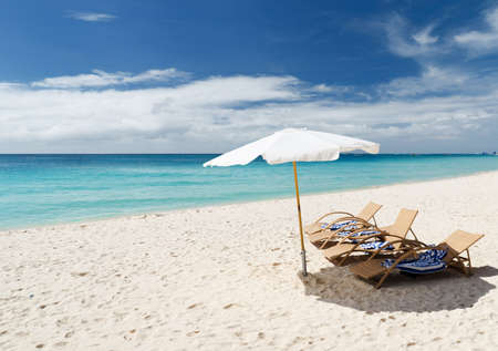 Chairs on white sand beach.の写真素材