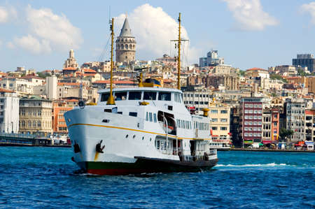 white ship in Bosporus with Galata Tower backgroundの写真素材