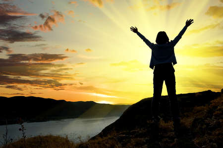 Woman in sunrise. Freedom concept.の写真素材