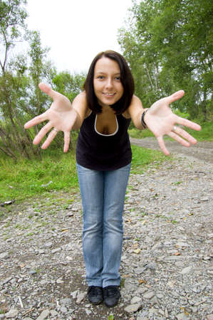 young woman greeting in parkの写真素材