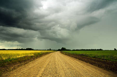 Stormy sky over the ground road.の写真素材