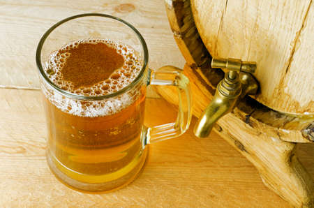 Beer and barrel on the wood table.の写真素材