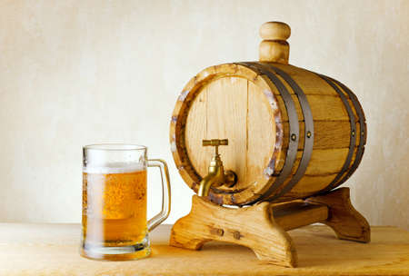 beer and barrel on the wood table.の写真素材