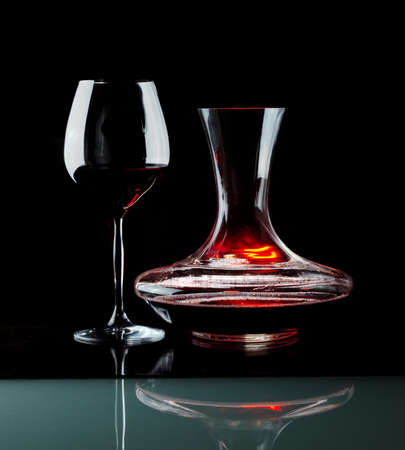 Decanting of red wine. Black background.の写真素材