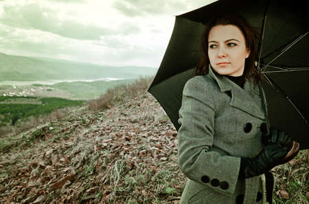 Young woman with black umbrella.の写真素材