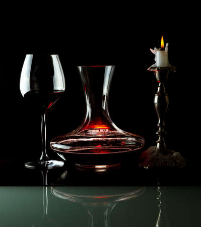 Decanting of red wine. Black background.の写真素材