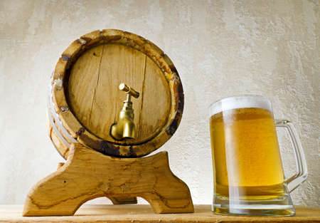 Beer and barrel on the wood table.の写真素材