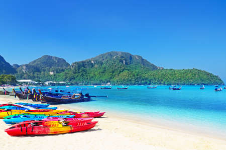 Colourful kayaks on tropical beach.の写真素材