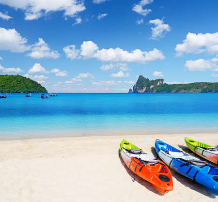 Colourful kayaks on tropical beach.の写真素材