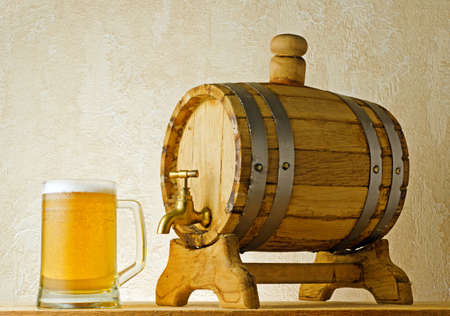 Beer and barrel on the wood table.の写真素材