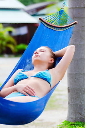 Young woman relaxing in a hammock の写真素材