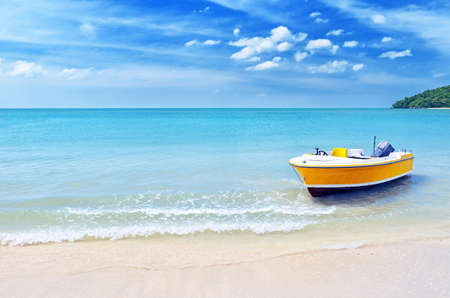 Yellow boat on a beach の写真素材