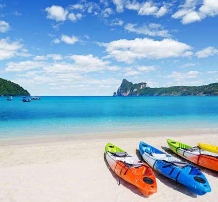Colourful kayaks on tropical beach.の写真素材