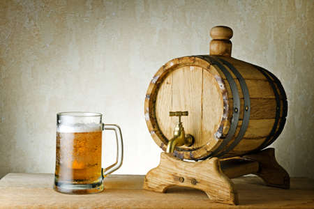 Beer and barrel on the wood table.の写真素材