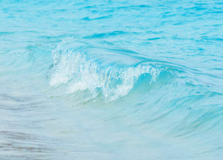 Blue wave on a beach. Shallow DOF.の写真素材
