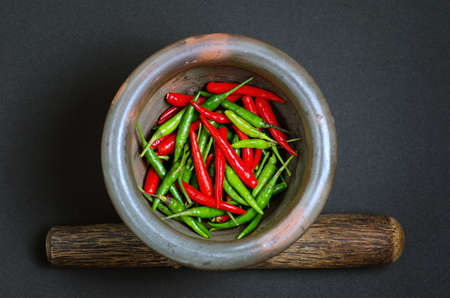 Red and green pepper in mortar の写真素材