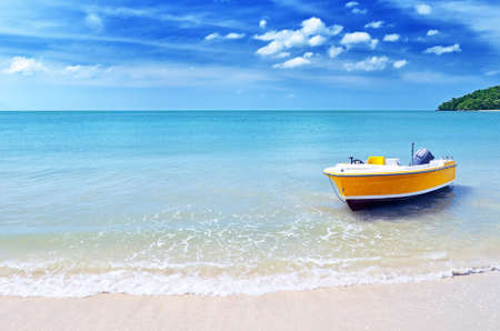 Yellow boat on a beach の写真素材