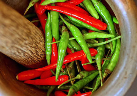 Red and green pepper in mortar.の写真素材