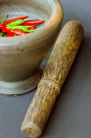 Red and green pepper in mortar.の写真素材
