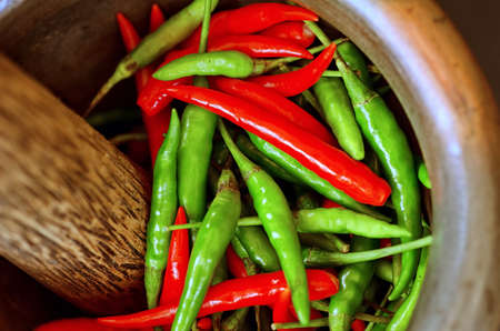 Red and green pepper in mortar.の写真素材