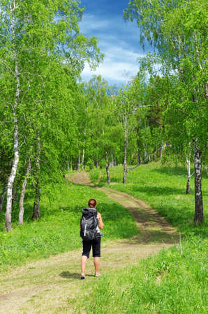 Woman with backpack in a forest.の写真素材