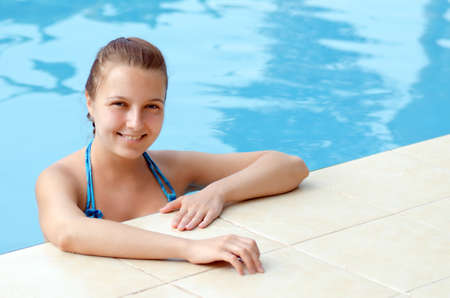 Young woman in a swimming pool.の写真素材