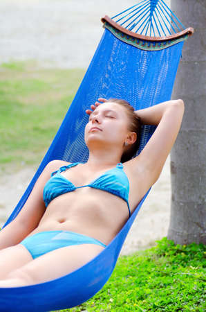 Young woman relaxing in a hammock.の写真素材