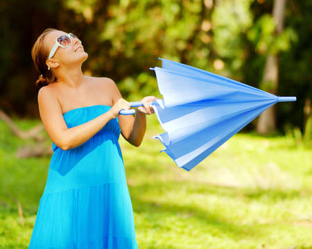 Young woman with umbrella. Outdoor portrait.の写真素材