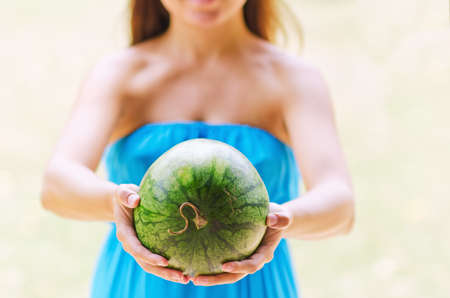 Young woman with watermelon in hands.の写真素材