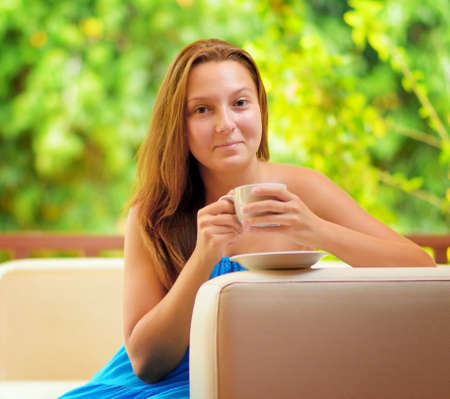 Young woman with cup of coffee.の写真素材