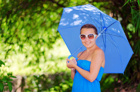 Young woman with umbrella. Outdoor portrait.の写真素材