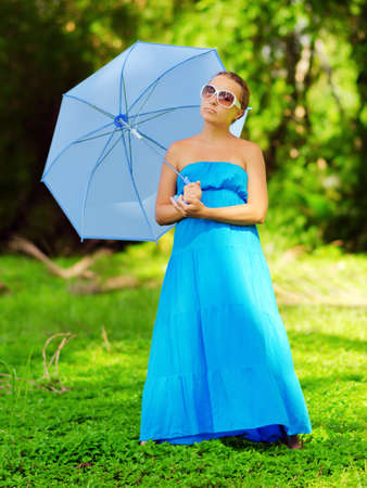 Young woman with umbrella. Outdoor portrait.の写真素材