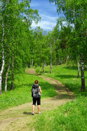 Woman with backpack in a forest.の写真素材