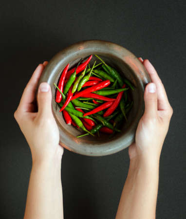 Red and green pepper in mortar の写真素材