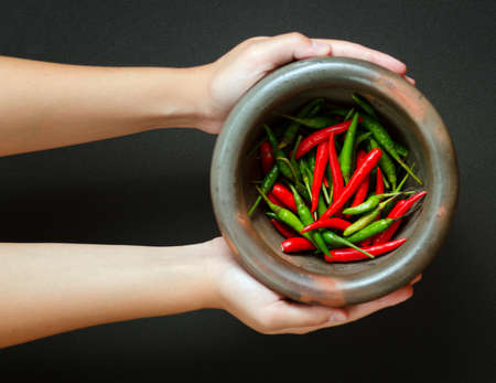 Red and green pepper in mortar の写真素材