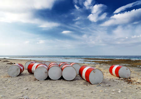Lot of oil barrels on a seashore  Environment pollution の写真素材