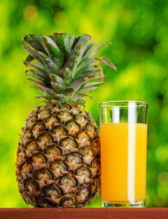 Glass of pineapple juice in a garden.の写真素材