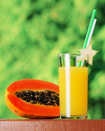 Glass of papaya juice in a garden.の写真素材