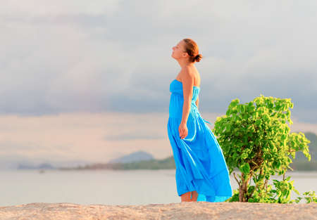 Young woman on a rocky beach.の写真素材