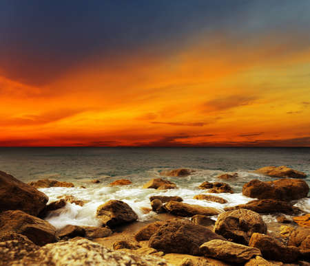 Red sky over a rocky seashore  Sunset landscape の写真素材
