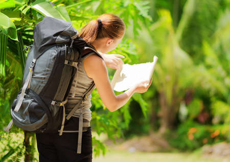 Young woman with backpack in a woods  Hiking at summertime の写真素材