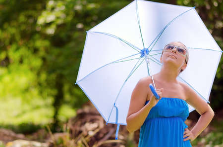 Young woman with umbrella. Outdoor portrait.の写真素材