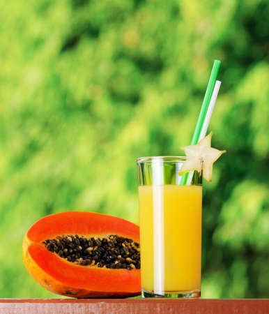 Glass of papaya juice in a garden.の写真素材