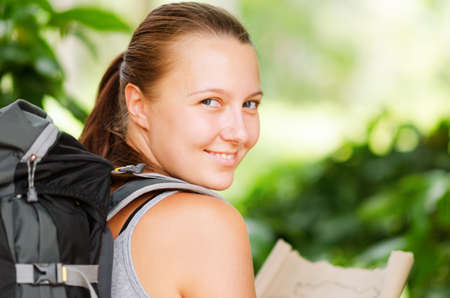 Young woman with backpack in a woods  Hiking at summertime の写真素材