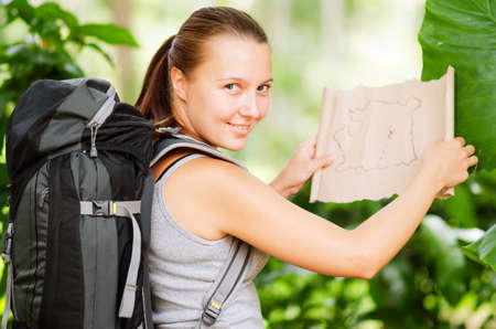 Young woman with backpack in a woods  Hiking at summertime の写真素材