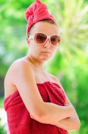 Glamorous woman in red towel の写真素材
