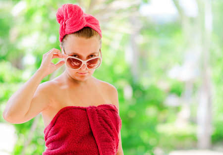 Glamorous woman in red towel の写真素材