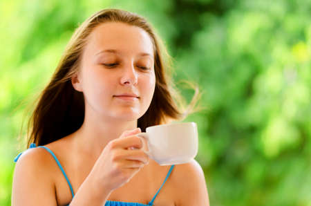 Woman enjoys cup of coffee の写真素材