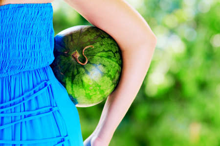 Young woman with watermelon in hands.の写真素材
